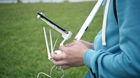 Man with remote controller,carefully controls the flying drone and having fun Stock-Footage 68957088
