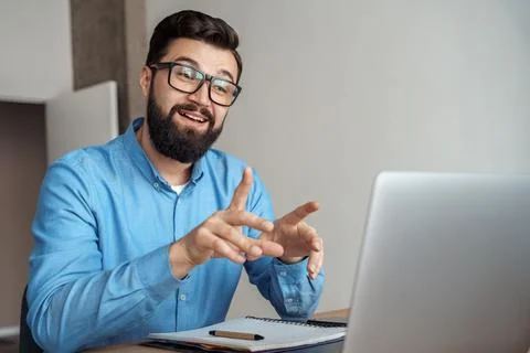 Man remote freelance worker having video conference meeting using laptop Stock Photos