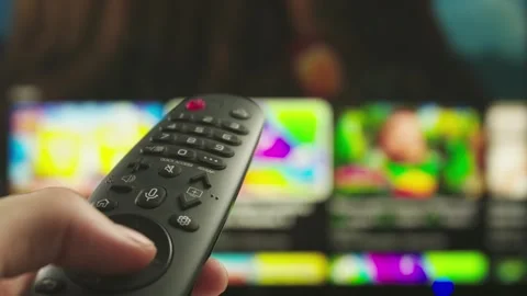 Man with remote in hand switching channels, rewinding video on smart tv Stock Footage 273820353