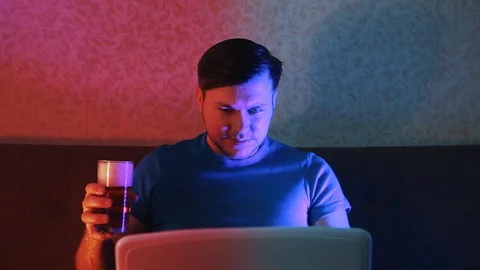 A man in a remote place drinks beer and communicates with his interlocutor. 스톡 동영상 129749847