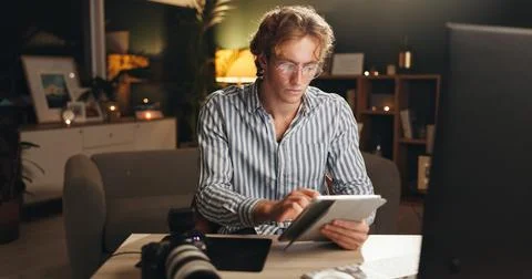 Man, remote work and tablet in home at night for editing, review images and.. Stock Photos