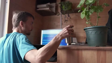 Man remote work home, drinking from can, stay home, candid lifestyle workplace Video stock 130494096