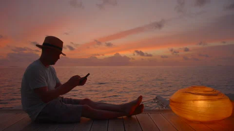 Man remote working in Luxury Vacation Villa at sunset Stock Footage 247282759