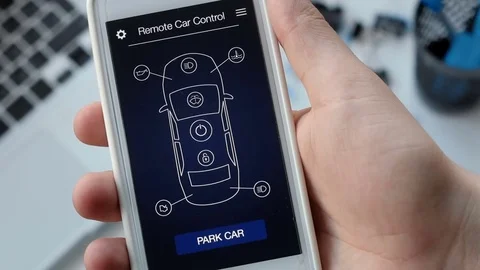 Man remotely parking his car. Car remote control using smartphone application Stock Footage