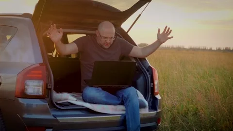 Man remotely working on laptop computer grabs his head when commits irreparable Stock Footage 248155883