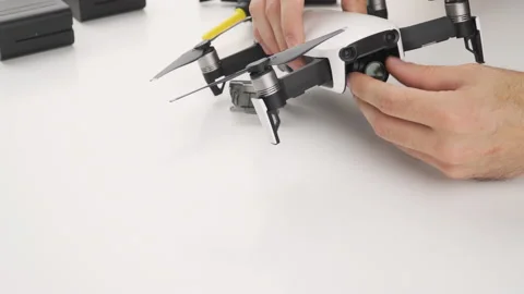 Man remove and install ND neutral density filter on drone Stock Footage 138046809