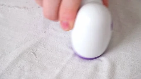 Man removes fabric pills using lint shaver. Stock Footage 201320738