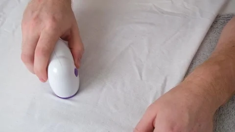 Man removes fabric pills using lint shaver. Stock Footage 202287601