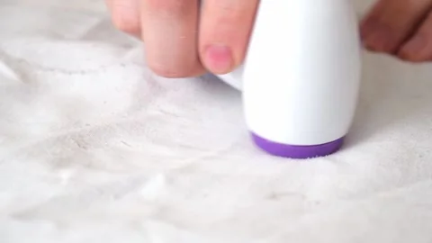 Man removes fabric pills using lint shaver. Stock Footage 202287619