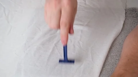 A man removes fabric pills using disposable shaving machine. A razor for Stock Footage 202287754