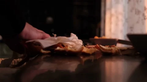 A man removes garbage after peeling fruit from the table in the kitchen Stock Footage 162714633