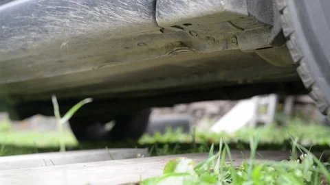 A man removes a hydraulic jack after changing a tire or wheel. Stock Footage 218813675