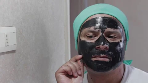 Man removes makeup from his face Stock Footage 327685822