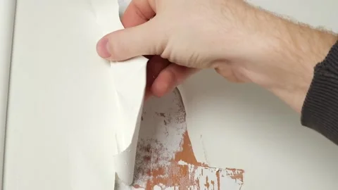 A man removes old white enamel paint from wooden door with a construction hair Stock-Footage 170852631