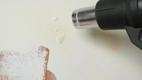 A man removes old white enamel paint from wooden door with a construction hair Stock Footage 170852676