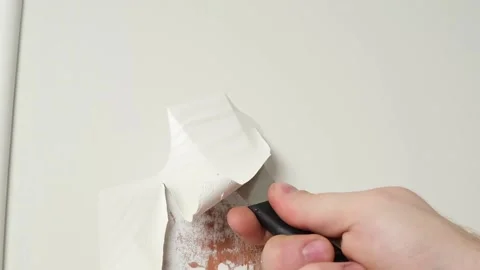 A man removes old white enamel paint from wooden door with a construction hair Video stock 171426714