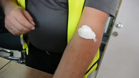 Man removes patch from his hand after blood donation	 스톡 동영상 131968356