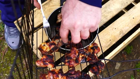 Man removes ready-made kebab from barbecue Stock Footage 151464591