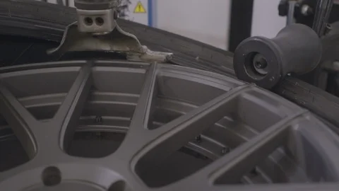 Man removes rubber from the car wheel Stock Footage 93523933