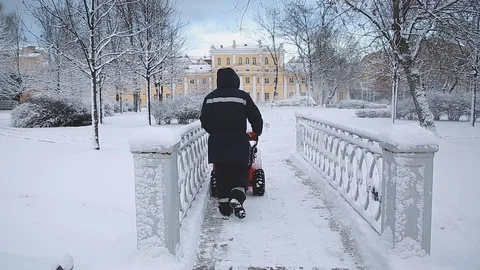 A man removes snow from the path Stock Footage 120692843