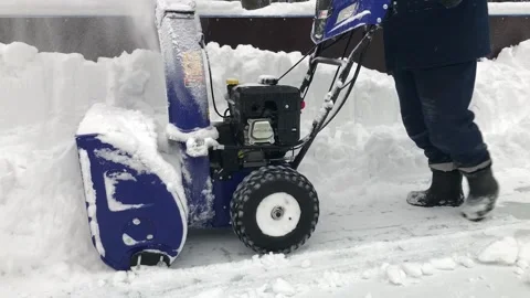 A man removes snow with a snowplow. Winter, snow removal work. Stock-Footage 169139727