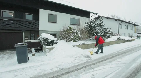 Man removes snow using snow showel Stock Footage 35970376