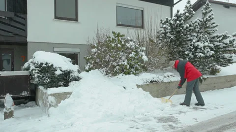 Man removes snow using snow showel Stock Footage 35970520