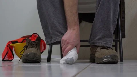 Man Removes Workboot Massages Foot Stock Footage 72005543