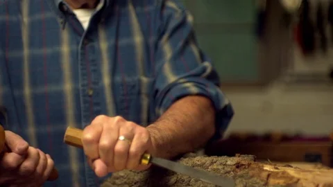 Man removing bark from chisel in slow motion 스톡 동영상 81311564