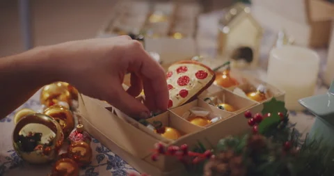 Man removing bauble from box at table Stock Footage 258333902