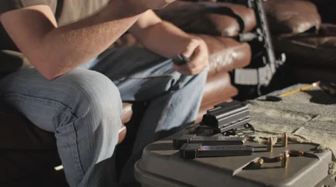 Man Removing Clip and Cleaning .45 Caliber Semi-Automatic Gun Stock Footage 60665441