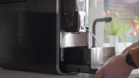 Man removing coffee grounds container from automatic coffee machine Stock Footage 328075517