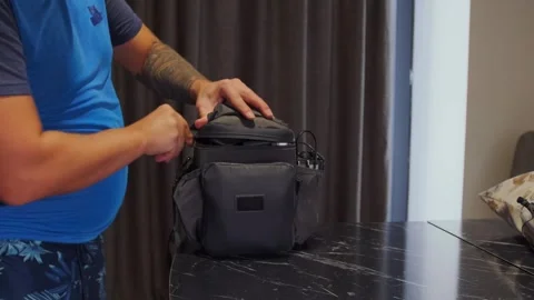 Man removing drone from carrying case indoors, preparing UAV for use, unpacking Stock Footage 333649527