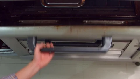 Man removing empanadas on a silver tray from a large oven Vidéo 75166719