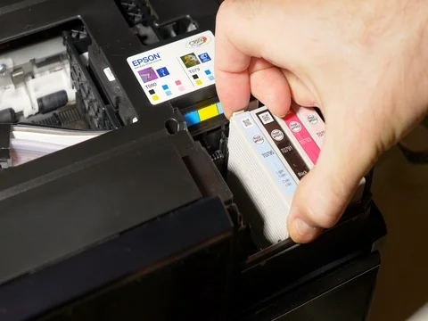 Man removing Epson printer cartridges Stock Footage 69378182