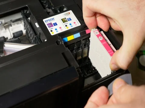 Man removing Epson printer cartridges Stock Footage 69378940