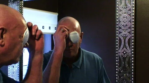 Man removing eye patch after cataract surgery Stock Footage 649984