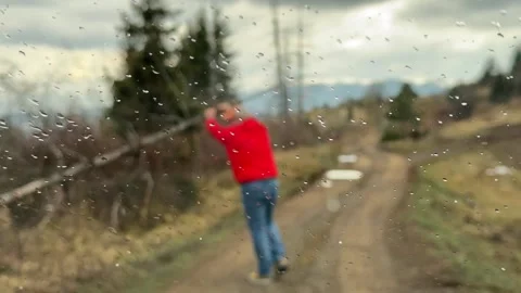 Man removing fallen tree from mountain road in Serbia travel obstacle concept Stock Footage 332067789