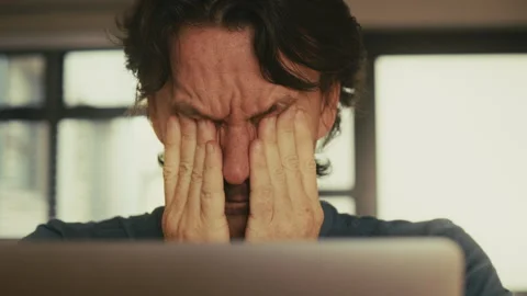 Man Removing Glasses Due to Eye Strain from Laptop.. Stock Footage 314439715