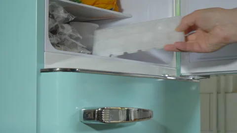 Man removing an ice cube tray from a freezer. Stock Footage 221231873