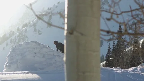 Man removing ice from a snow cliff with shovel Stock Footage 77764939