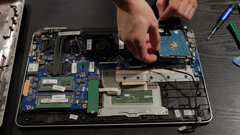 Man Removing Laptop Hard Drive Stock Footage 101404728