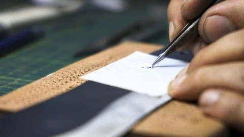 Man removing the logo mask from knife before the electro corrosion Stock Footage 126703922