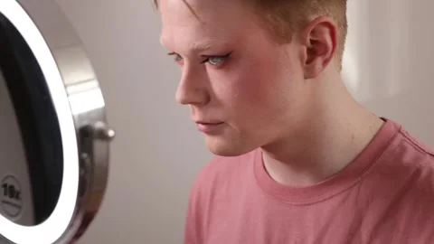 Man Removing Makeup with Cotton Pad in Front of Mirror Stock Footage 310031487