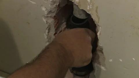 Man removing pipe Stock Footage 57714431