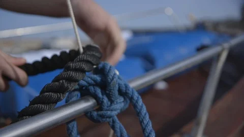 Man removing rope from boat Stock Footage 89978646