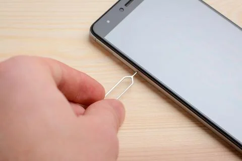 Man removing SIM and micro SD tray Stock Photos