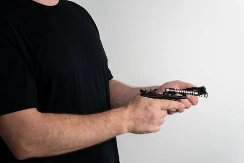 Man removing slide from semi automatic pistol during disassembly Fotos Stock