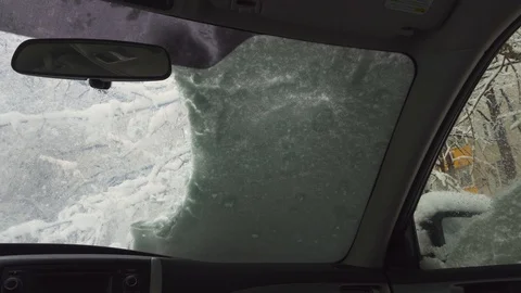 Man removing snow from windshield after heavy snowfall in winter. 4k Stock Footage 103135010