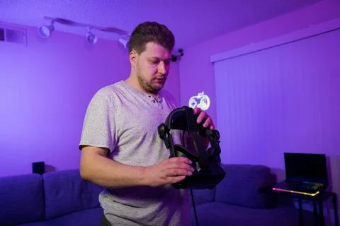 Man removing VR headset after gaming session Stock Photos
